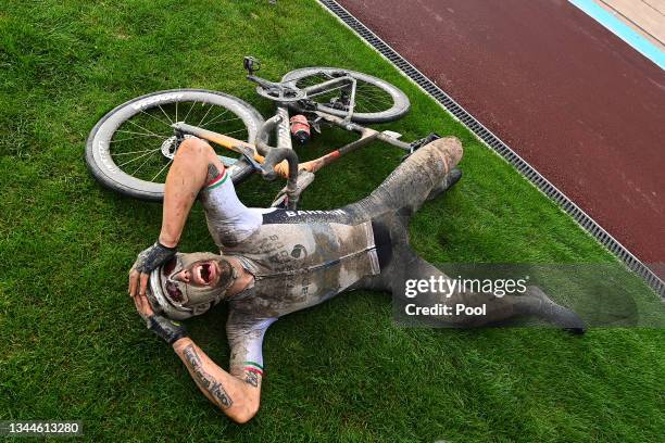 Sonny Colbrelli of Italy and Team Bahrain Victorious covered in mud celebrates winning in the Roubaix Velodrome - Vélodrome André Pétrieux after the...