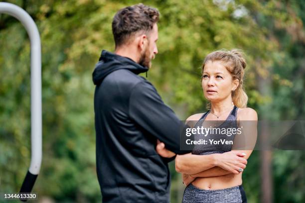 fitness talking together in the park - 45 couple stockfoto's en -beelden