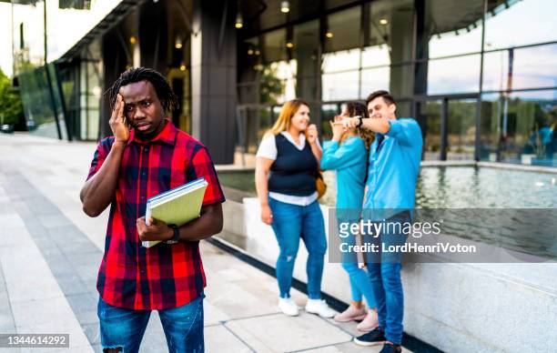 young black man rejected by a group - cruelity stock pictures, royalty-free photos & images