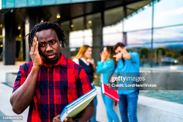 young black man rejected by a group - racism stock pictures, royalty-free photos & images