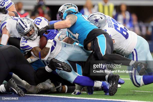 Ezekiel Elliott of the Dallas Cowboys runs the ball for a touchdown during the first quarter against the Carolina Panthers at AT&T Stadium on October...