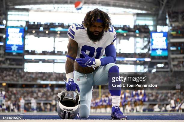 Ezekiel Elliott of the Dallas Cowboys kneels in the endzone before the game against the Carolina Panthers at AT&T Stadium on October 03, 2021 in...
