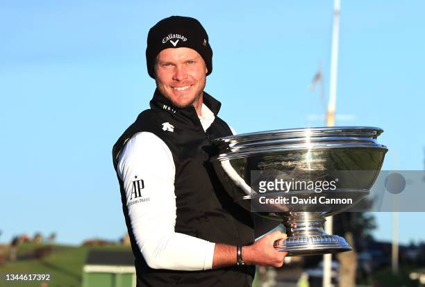 Danny Willett of England poses with the trophy on the Swilcan Bridge after the final round of The Alfred Dunhill Links Championship on The Old Course...
