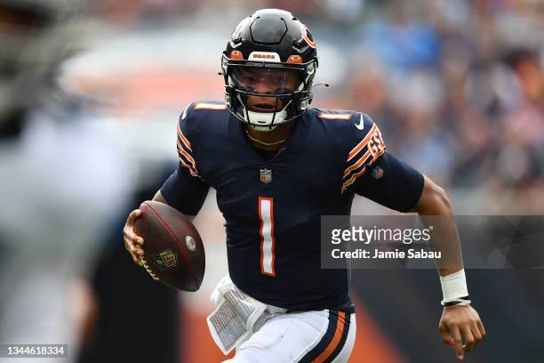 Quarterback Justin Fields of the Chicago Bears runs with the ball against the Detroit Lions in the first half at Soldier Field on October 03, 2021 in...
