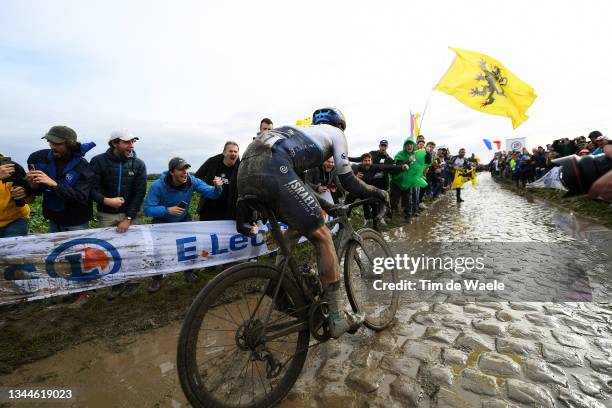 Tom Van Asbroeck of Belgium and Team Israel Start-Up Nation covered in mud covered in mud competes through cobblestones sector during the 118th...