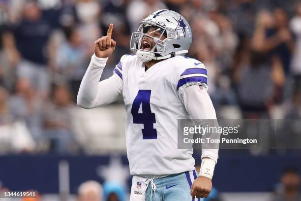 Dak Prescott of the Dallas Cowboys celebrates a touchdown during the second quarter against the Carolina Panthers at AT&T Stadium on October 03, 2021...