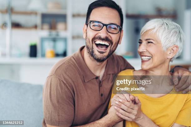 happy mother looking at her adult son - old woman young man stock pictures, royalty-free photos & images