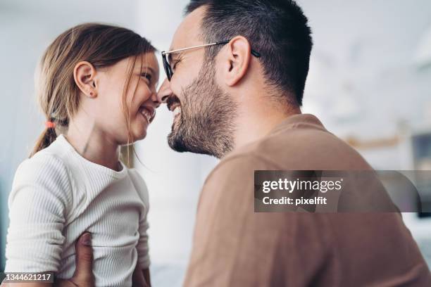 happy father and little daughter rubbing noses - child wearing adult glasses stock pictures, royalty-free photos & images