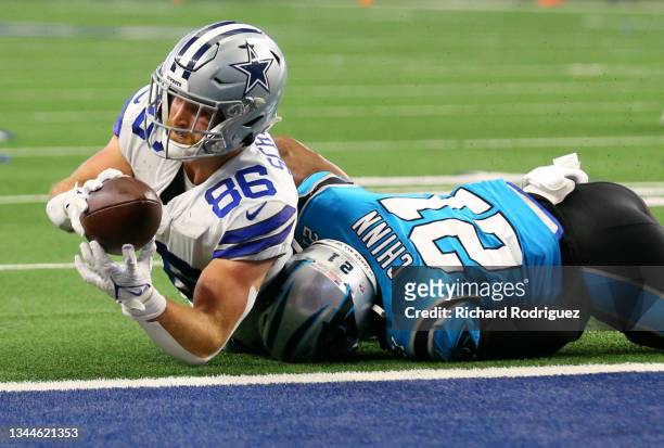 Dalton Schultz of the Dallas Cowboys is stopped short of the goal line by Jeremy Chinn of the Carolina Panthers during a two-point conversion try...