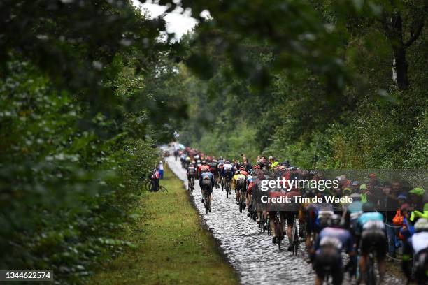 General view of the peloton passing through Trouée d'Arenberg cobblestones sector during the 118th Paris-Roubaix 2021 - Men's Eilte a 257,7km race...