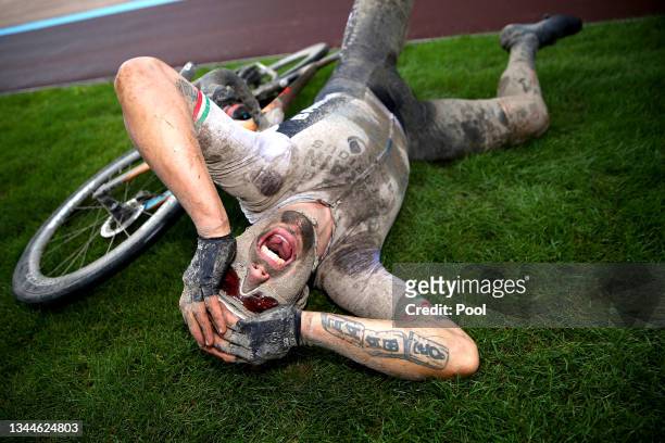 Sonny Colbrelli of Italy and Team Bahrain Victorious covered in mud celebrates winning in the Roubaix Velodrome - Vélodrome André Pétrieux after the...