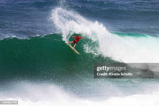 Taj Burrow of Australia surfs during the round of 64 at the Vans World Cup of Surfingon December 1, 2011 in Sunset Beach, United States.