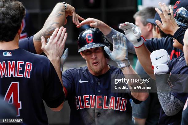 Myles Straw of the Cleveland Indians is greeted by teammates after scoring a run in the first inning against the Texas Rangers at Globe Life Field on...