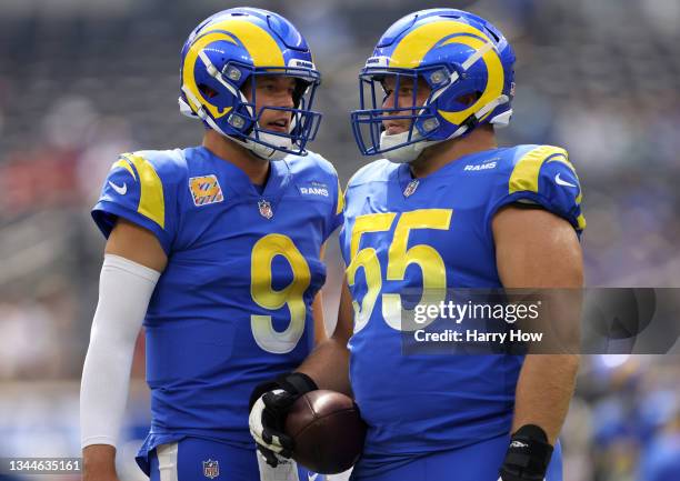 Matthew Stafford and Brian Allen of the Los Angeles Rams warm up before the game against the Arizona Cardinals at SoFi Stadium on October 03, 2021 in...