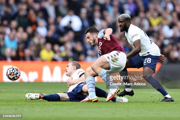 John McGinn of Aston Villa in action with Oliver Skipp and Tanguy Ndombele of Tottenham Hotspur during the Premier League match between Tottenham...