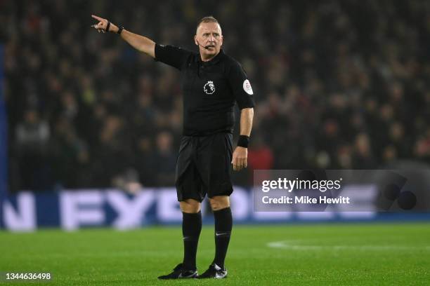 Referee Jonathan Moss signals during the Premier League match between Brighton & Hove Albion and Arsenal at American Express Community Stadium on...