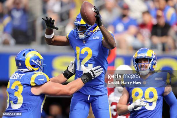 Van Jefferson of the Los Angeles Rams jumps into the arms of Austin Corbett to celebrate his first quarter touchdown against the Arizona Cardinals at...