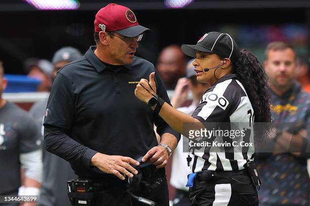 Head coach Ron Rivera of the Washington Football Team talks with Line Judge Maia Chaka during the fourth quarter in the game against the Atlanta...
