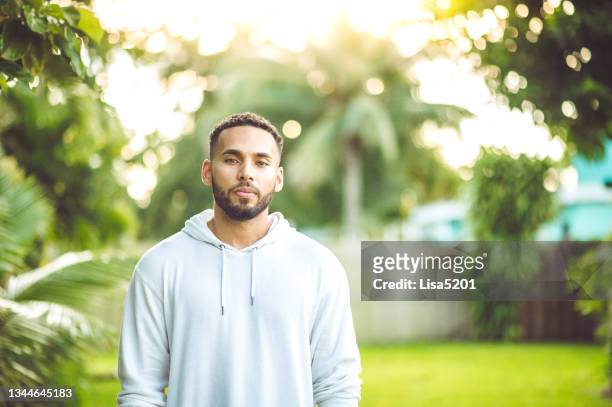 handsome adult mixed race man in moody casual outdoor portrait - hooded shirt stock pictures, royalty-free photos & images
