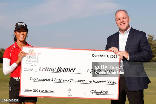 Chief Customer Officer Steve Henig of Wakefern Food Corporation presents Celine Boutier of France with a check after her win during the final round...