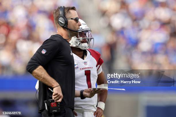 Head coach Kliff Kingsbury and Kyler Murray of the Arizona Cardinals talk on the side line during the first half of the game against the Los Angeles...