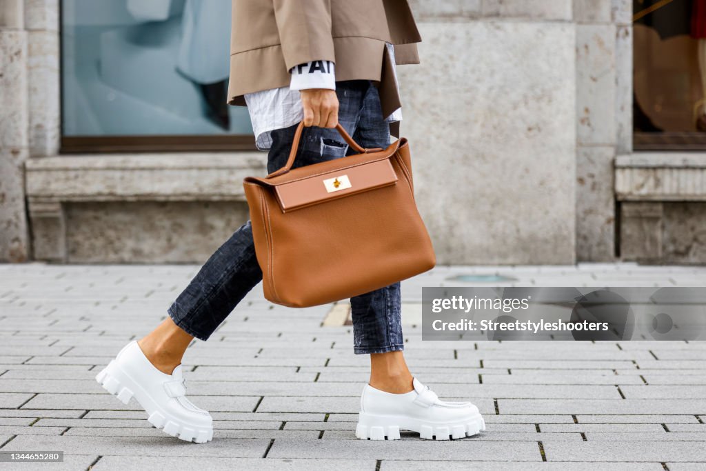 A brown 24/24 Hermes bag as a streetstyle shooting with influencer News  Photo - Getty Images
