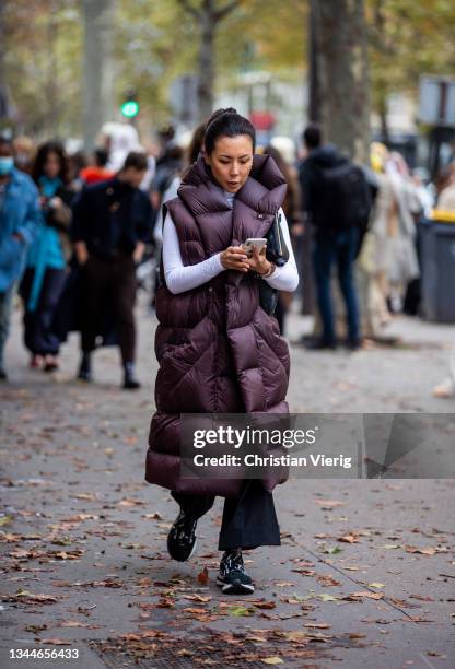 Guest is seen wearing sleeveless down feather coat outside Ann Demeulemeester during Paris Fashion Week - Womenswear Spring Summer 2022 on October...