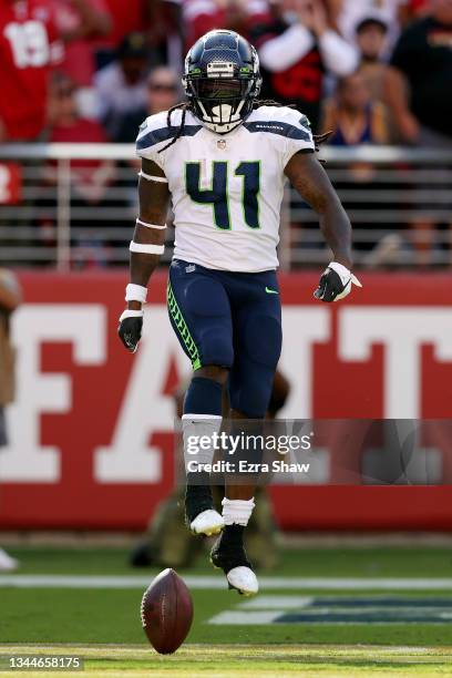 Alex Collins of the Seattle Seahawks celebrates after running for a touchdown during the fourth quarter against the San Francisco 49ers at Levi's...