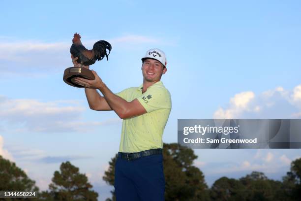 Sam Burns poses with the trophy after winning during the final round of the Sanderson Farms Championship at Country Club of Jackson on October 03,...