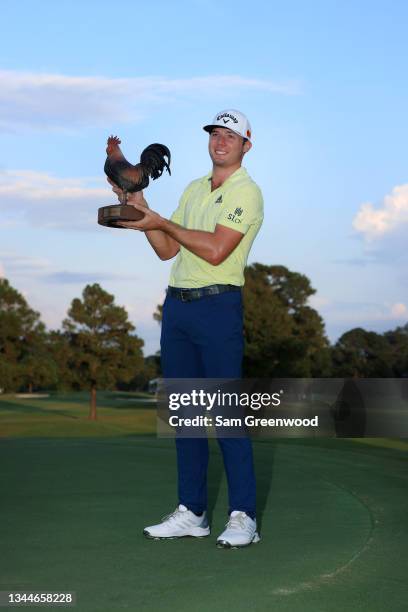 Sam Burns poses with the trophy after winning during the final round of the Sanderson Farms Championship at Country Club of Jackson on October 03,...