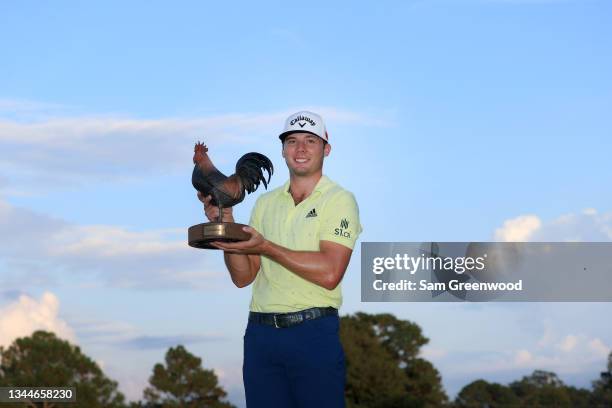 Sam Burns poses with the trophy after winning during the final round of the Sanderson Farms Championship at Country Club of Jackson on October 03,...