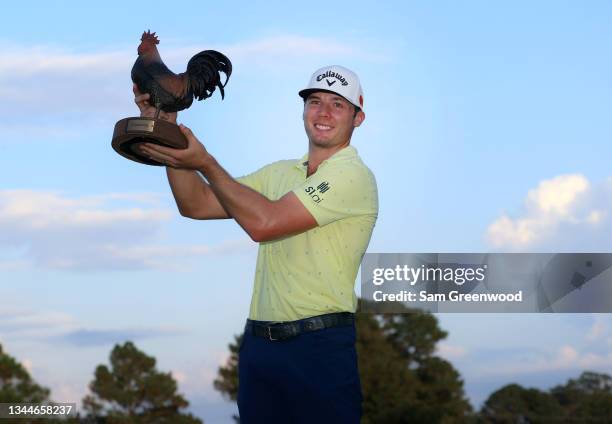 Sam Burns poses with the trophy after winning during the final round of the Sanderson Farms Championship at Country Club of Jackson on October 03,...