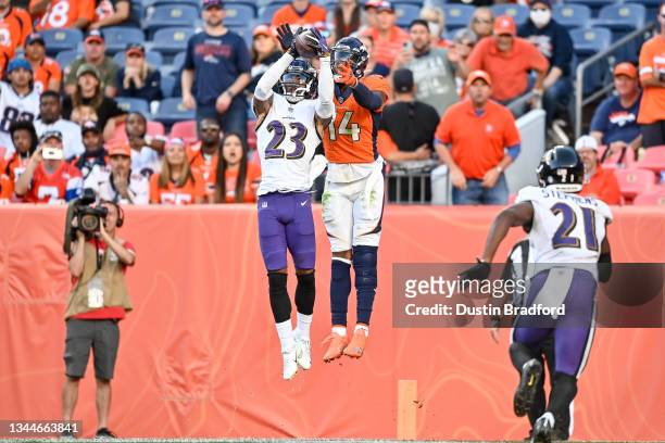 Anthony Averett of the Baltimore Ravens intercepts a pass intended for Courtland Sutton of the Denver Broncos in the fourth quarter of a game at...