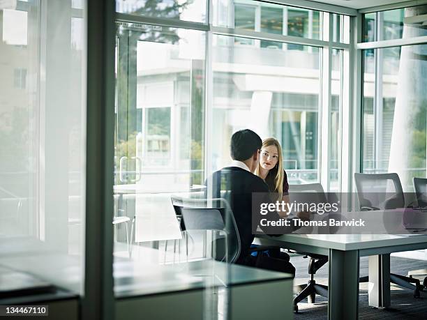 coworkers in discussion in conference room - conference 2011 stock pictures, royalty-free photos & images