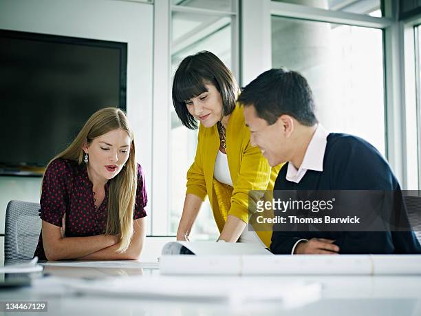coworkers in discussion at conference table - liquid crystal display stock pictures, royalty-free photos & images