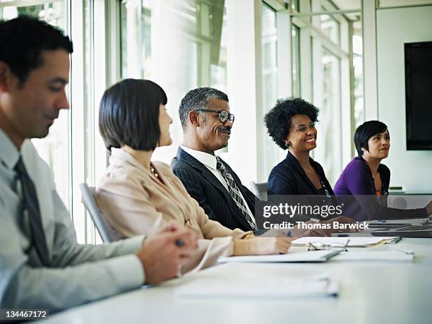 group of coworkers at conference table - boardroom stock pictures, royalty-free photos & images