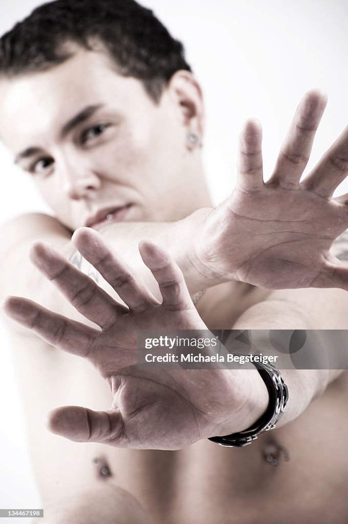 Young man with hands in front of the face
