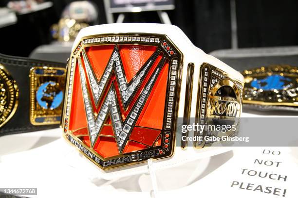 Replica of Ronda Rousey's WWE Raw women's championship belt is displayed in the Wrestling Revolution booth during Unicon 2021 at the World Market...