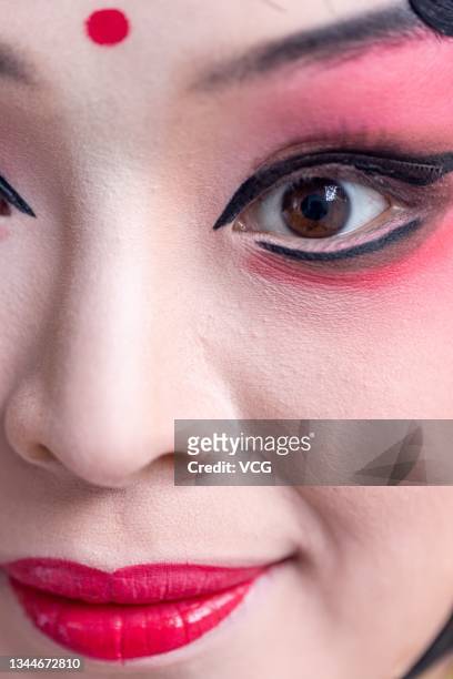 Detail view an actress in the backstage prior to a performance during the 5th Chinese Opera Culture Week at Beijing Garden Expo Park on October 2,...