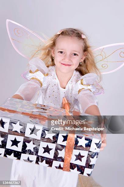 girl as angel with christmas present - luxury lounges stock pictures, royalty-free photos & images