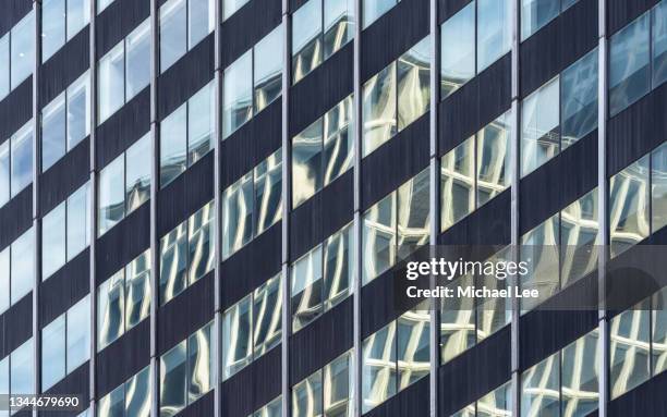 distorted reflection on glass facade of office tower in midtown manhattan - park ave stock pictures, royalty-free photos & images