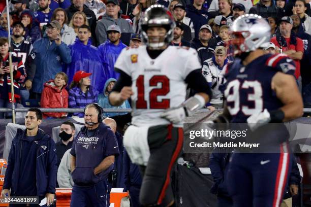 Head coach Bill Belichick of the New England Patriots looks on as Tom Brady of the Tampa Bay Buccaneers runs past during the fourth quarter in the...