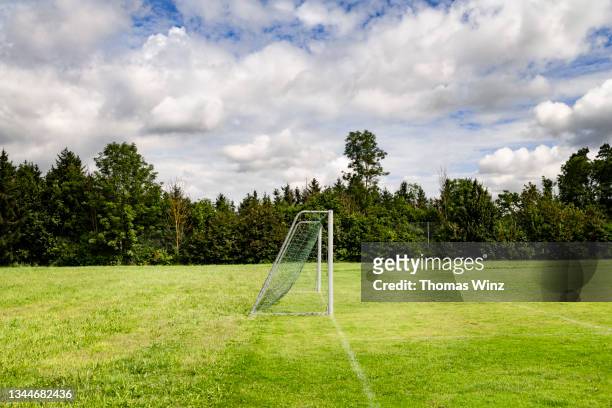 soccer goal and field in the countryside - soccer goal stock-fotos und bilder