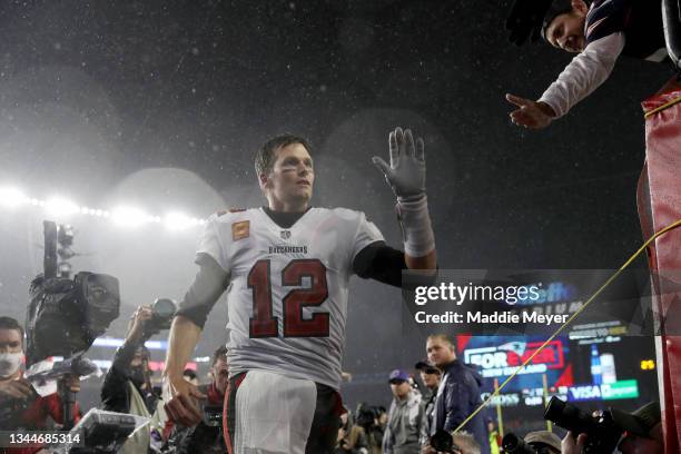 Tom Brady of the Tampa Bay Buccaneers waves to the crowd as he runs off the field after defeating the New England Patriots in the game at Gillette...