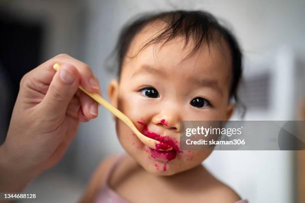 asian baby happiness using hand try to  eating dragon fruit  dirty and messy - hot dirty girl stock pictures, royalty-free photos & images