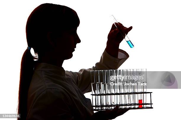 chemistry laboratory, lab technician at work - silhouette contre jour fotografías e imágenes de stock