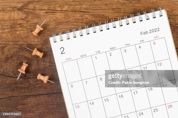 calendar desk 2022 on february month, the concept of planning and deadline with push pin on calendar date. - schedule stock pictures, royalty-free photos & images