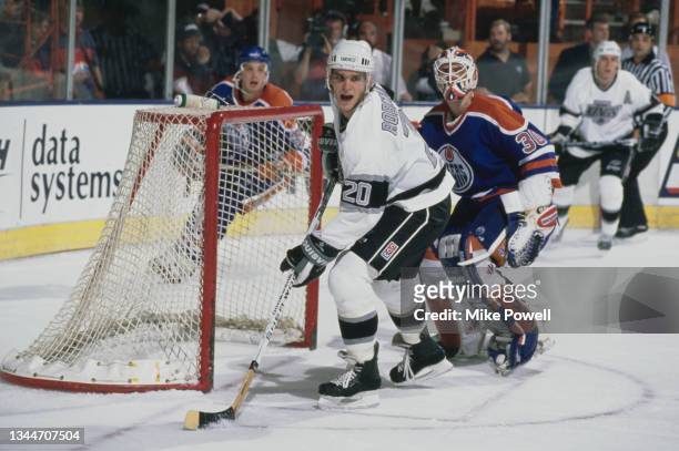 Luc Robitaille from Canada and Left Wing for the Los Angeles Kings and compatriot Bill Ranford, Goaltender for the Edmonton Oilers in motion on the...