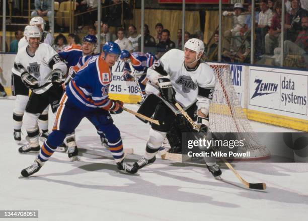 Ken Baumgartner from Canada and Defenseman for the Los Angeles Kings and Jari Kurri from Finland, Right Wing for the Edmonton Oilers in motion on the...