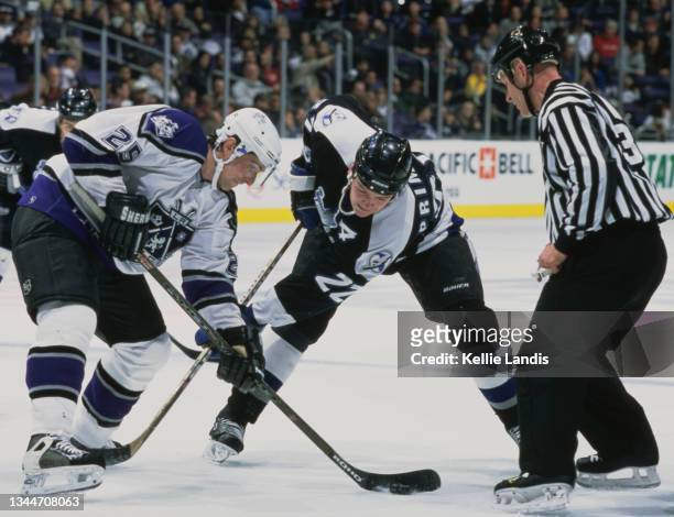 Eric Belanger from Canada and Center for the Los Angeles Kings and compatriot Wayne Primeau of the Tampa Bay Lightning face off during their NHL...